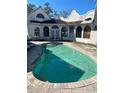Backyard pool with weathered patio, offering potential for outdoor relaxation and entertainment at 1827 2Nd E Ave, Bradenton, FL 34208