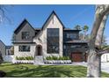 Beautifully designed two-story home with stone and dark siding accents and lush green lawn at 1056 Snell Isle Ne Blvd, St Petersburg, FL 33704