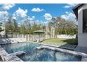 Inviting backyard pool and spa area with an umbrella and lounge chairs for relaxation at 1056 Snell Isle Ne Blvd, St Petersburg, FL 33704