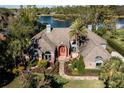 Beautiful waterfront home with meticulous landscaping and an inviting entrance and pathway at 7705 Weeping Willow Cir, Sarasota, FL 34241
