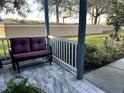 Relaxing porch with a comfortable bench and decorative tile flooring at 12209 Putter Green Ct, New Port Richey, FL 34654