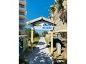 Sign that reads Beach Access with a pathway leading to the beach and condominium buildings on either side at 19417 Gulf Blvd # B209, Indian Rocks Beach, FL 33785