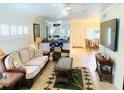 Living room with a sofa and chairs, tile floor and tropical-themed decor at 19417 Gulf Blvd # B209, Indian Rocks Beach, FL 33785