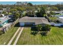 Spacious home with manicured lawn, long driveway and mature palms; backyard privacy fencing at 12339 138Th N St, Largo, FL 33774