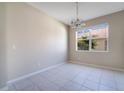 Spacious dining room with tile flooring, a chandelier, and a large window offering natural light at 15107 Searobbin Dr, Lakewood Ranch, FL 34202