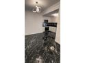 Modern kitchen with black marble floors, stainless steel appliances, and white cabinets at 501 Knights Run Ave # 2106, Tampa, FL 33602