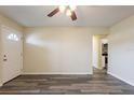 Open living room showing new gray vinyl flooring, neutral paint, and an opening to the kitchen area at 8528 Gold Ridge Cir, Tampa, FL 33619