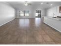 Spacious living room with ceramic tile flooring, large windows, and lots of natural light at 36017 Stable Wilk Ave, Zephyrhills, FL 33541