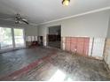 Spacious living room with sliding glass doors and ceiling fan, undergoing renovation at 1501 Delaware Ne Ave, St Petersburg, FL 33703