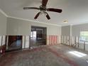 Open-concept living area with ceiling fan, showcasing interior undergoing renovations and exposed framework at 1501 Delaware Ne Ave, St Petersburg, FL 33703