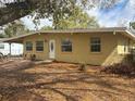 Charming one-story home with front lawn and lots of shade trees at 411 Shore E Dr, Oldsmar, FL 34677