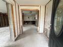 An interior shot of the entry way that leads to a room with exposed framing, ready for renovation at 4200 Huntington Ne St, St Petersburg, FL 33703