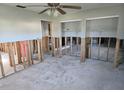 Spacious living room ready for renovation, featuring a ceiling fan and natural light at 4706 Lansing Ne St, St Petersburg, FL 33703