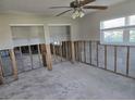 Spacious living room ready for renovation, featuring a ceiling fan and natural light at 4706 Lansing Ne St, St Petersburg, FL 33703