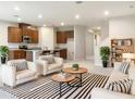 Bright living room featuring modern furniture, open kitchen, and sleek finishes at 6310 116Th E Ave, Parrish, FL 34219