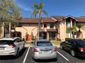 Exterior view of a multi-unit residential building with well-maintained landscaping and ample parking space at 6211 Timber Lake Dr # B4, Sarasota, FL 34243