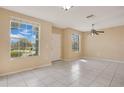 Bright living room with large windows offering ample natural light and tile flooring throughout at 1580 Blue Magnolia Rd, Brandon, FL 33510