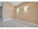 A spacious and bright room with neutral walls and white tile flooring, ready for customization at 7622 Hampshire Garden Pl, Apollo Beach, FL 33572