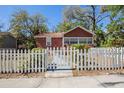 Inviting brick home with a classic white picket fence enhancing its curb appeal at 2011 10Th S St, St Petersburg, FL 33705