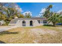 Charming one-story home features stucco and lush landscaping in a peaceful neighborhood at 3207 N 45Th St, Tampa, FL 33605