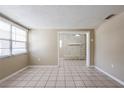 Spacious room showcasing the neutral interior and tile floors at 3207 N 45Th St, Tampa, FL 33605