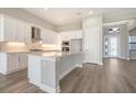 Bright kitchen features white cabinets, stainless steel appliances, subway tile backsplash, and a large island with marble countertops at 4541 Mondrian Ct, Sarasota, FL 34240