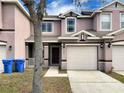 Charming two-story townhome featuring an attached garage and a neatly landscaped front yard with beautiful architectural details at 523 Glenn Cross Dr, Ruskin, FL 33570