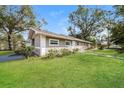 Attractive home featuring a lush green lawn and tidy landscaping in a suburban setting at 1501 Neil St, Plant City, FL 33563