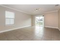 Bright living room with tile floors, sliding glass doors and neutral color palette at 2303 Ashberry Ridge Dr, Plant City, FL 33563