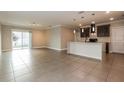 Open-concept living space featuring tile flooring and a modern kitchen with a breakfast bar at 2303 Ashberry Ridge Dr, Plant City, FL 33563
