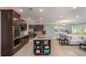 Bright open-concept living space with a large kitchen island, dining area, and comfortable living room at 22500 Provance Ave, Port Charlotte, FL 33954