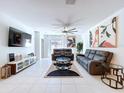 Inviting living room featuring contemporary decor, tile floors, and a comfortable seating arrangement at 6471 Beverly Hills Dr, Zephyrhills, FL 33541