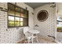 Inviting outdoor patio with a decorative metal sun and cozy seating for relaxing outside at 12205 Kelly Ln, Thonotosassa, FL 33592