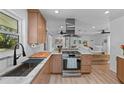 Bright kitchen with a stainless steel range hood, gas range, and butcher block countertop at 1767 Colorado Ne Ave, St Petersburg, FL 33703