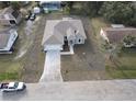 A stunning aerial view of a charming one-story home with ample parking space and lush trees at 383 Yeager St, Port Charlotte, FL 33954