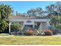 Exterior view of the clubhouse entrance with lush tropical landscaping at 1000 Cove Cay Dr # 5E, Clearwater, FL 33760