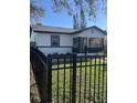 Charming home with fenced yard, manicured landscaping, teal front door, and black and white trim at 2032 22Nd S Ave, St Petersburg, FL 33712