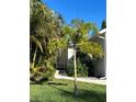 Well-maintained home with lush landscaping, including a palm tree and vibrant green lawn at 424 N Carolina Ave, Palm Harbor, FL 34683