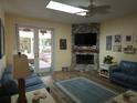 Bright and airy living room with stone fireplace, skylight, and patio access at 424 N Carolina Ave, Palm Harbor, FL 34683