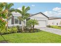 Inviting single-story home boasting a well-maintained lawn, meticulous landscaping, and a convenient two-car garage at 467 Sun Chaser Dr, Nokomis, FL 34275