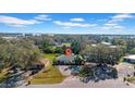 Aerial view of a home nestled among lush trees in a residential neighborhood with city views at 1616 39Th Avenue E Dr, Ellenton, FL 34222