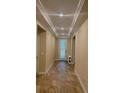 Elegant foyer features tray ceiling, tile floors, and a front door with decorative glass panel at 23149 Hammond Ave, Port Charlotte, FL 33954