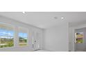 Bright living area with tile floors, lots of light, and a glass door leading to the outdoors at 349 Gold Tree, Punta Gorda, FL 33955
