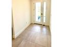 Bright foyer featuring neutral ceramic tiles and a white front door that lets in ample natural light at 7343 N Ficus Tree, Punta Gorda, FL 33955
