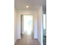 Bright hallway with tile flooring, neutral walls and a door leading to a carpeted room at 7343 N Ficus Tree, Punta Gorda, FL 33955