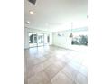 Open concept living room with tile flooring, recessed lighting and large sliding glass doors to the outdoors at 7343 N Ficus Tree, Punta Gorda, FL 33955