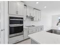 Well-equipped kitchen with stainless steel appliances, ample counter space, and stylish cabinetry at 1844 Draughton Dr, Zephyrhills, FL 33541