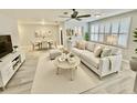 A beautifully staged living and dining area with neutral tones, modern furniture, and ample natural light at 5521 80Th Street North # 306, St Petersburg, FL 33709