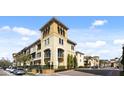 Charming condo complex featuring a stucco facade, tower accents, and well-maintained landscaping at 116 S Obrien St, Tampa, FL 33609
