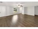 A spacious, bright living room features attractive floors and a ceiling fan at 523 Red Mangrove Ln, Apollo Beach, FL 33572